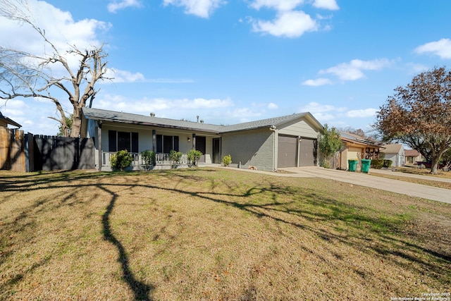 single story home featuring a garage, a front yard, and covered porch