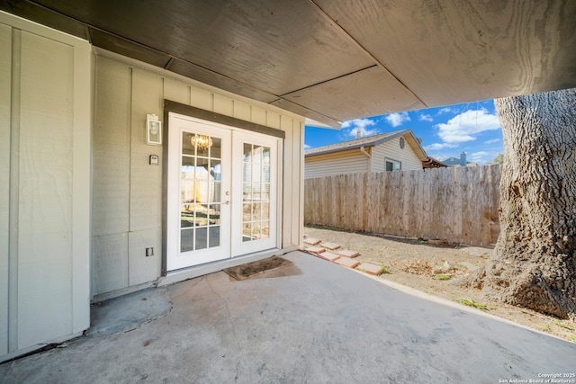 property entrance featuring a patio and french doors