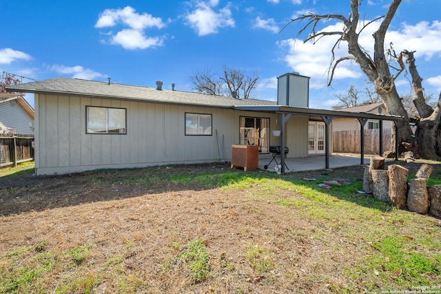 back of house featuring a yard and a patio