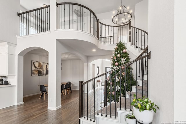 foyer entrance with a high ceiling, a chandelier, and dark hardwood / wood-style flooring