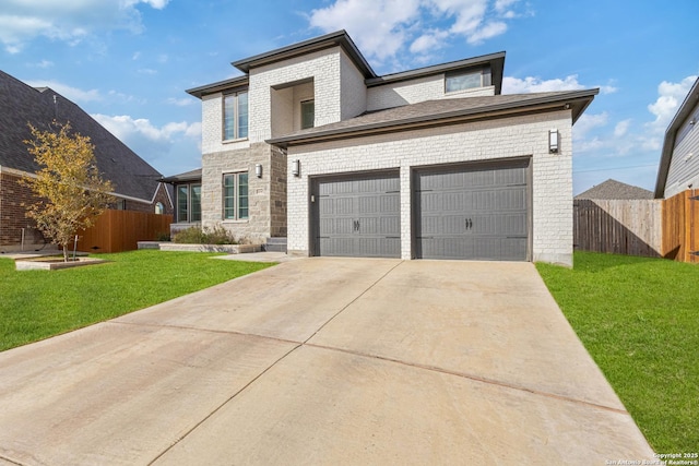 view of front of house with a garage and a front lawn