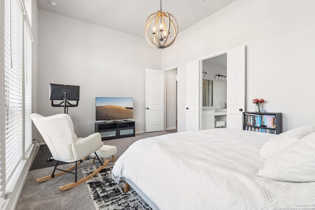 carpeted bedroom with a notable chandelier