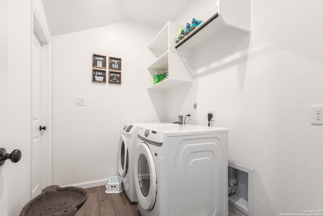 laundry area with wood-type flooring and washer and clothes dryer