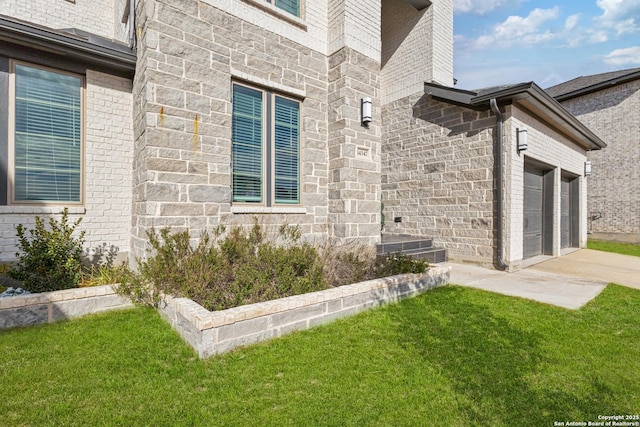 view of exterior entry featuring a lawn