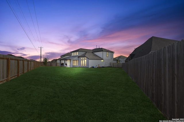 view of yard at dusk