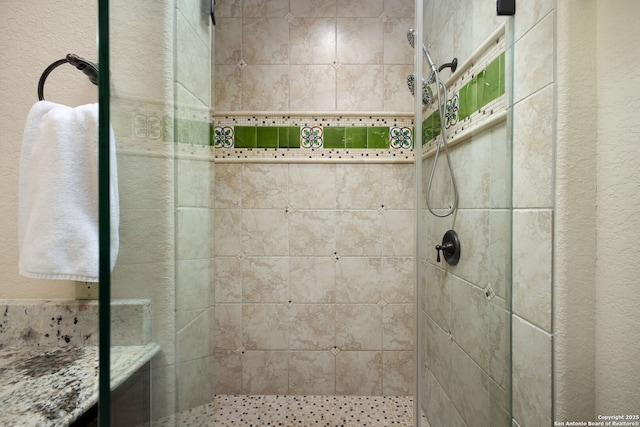 bathroom with tiled shower