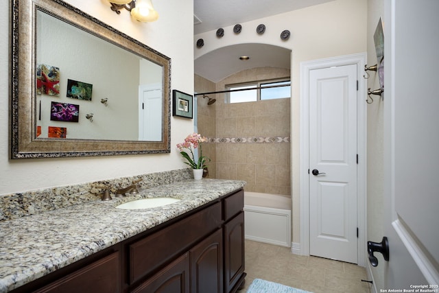 bathroom featuring vanity and tiled shower / bath