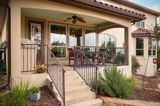 view of exterior entry with ceiling fan