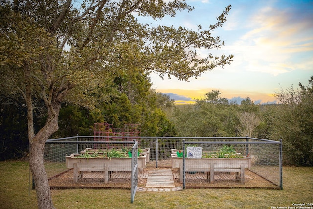 playground at dusk featuring a lawn