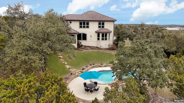 back of house with a yard and a patio area