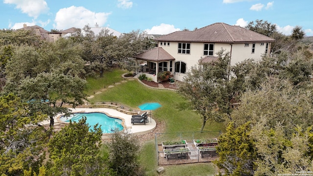 view of swimming pool featuring a lawn and a patio