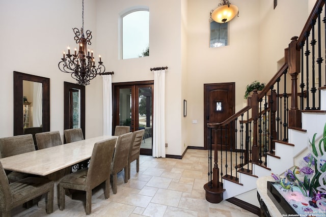 dining room featuring a notable chandelier, french doors, and a high ceiling