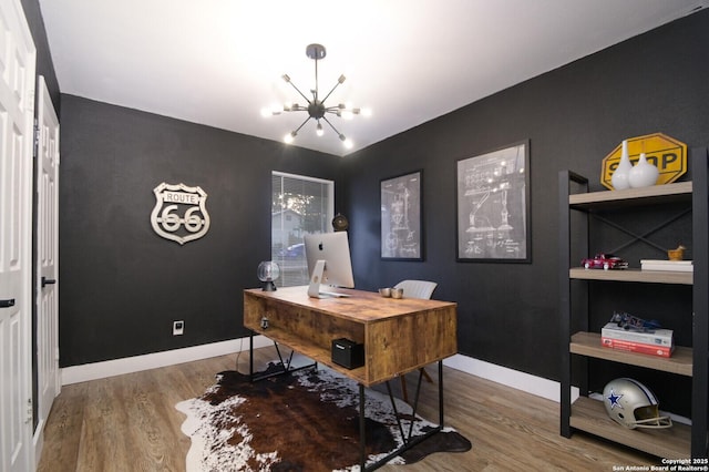 home office featuring hardwood / wood-style flooring and a notable chandelier