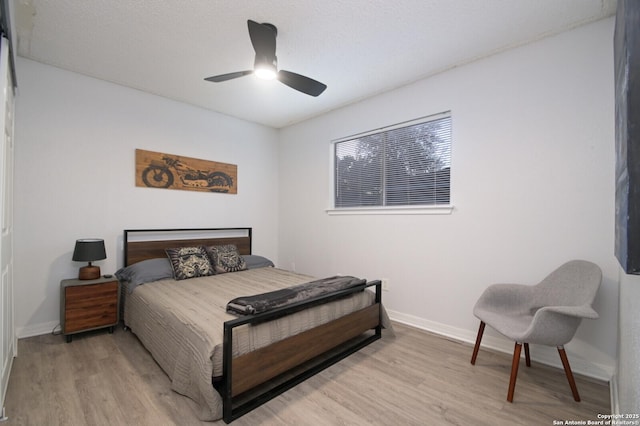 bedroom featuring ceiling fan and light hardwood / wood-style flooring