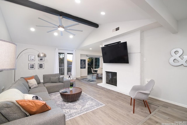 living room featuring vaulted ceiling with beams, hardwood / wood-style flooring, and ceiling fan