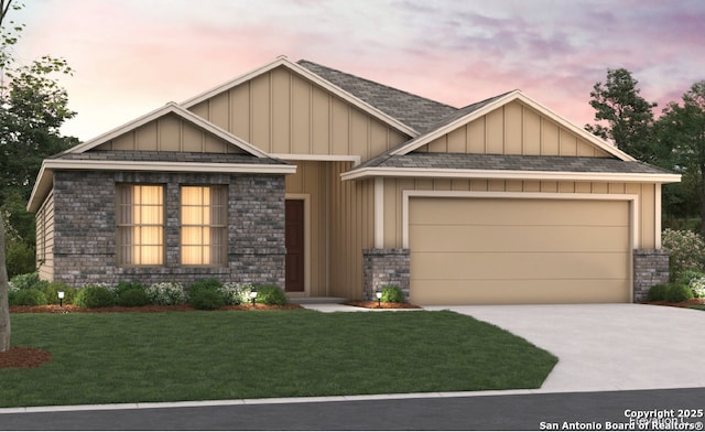 craftsman house with a yard, a garage, board and batten siding, and concrete driveway