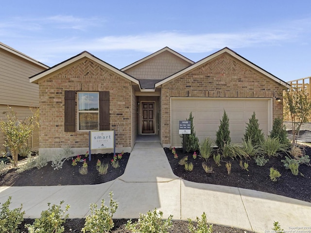 ranch-style home featuring a garage and brick siding