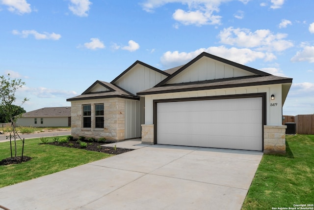 8419 Hamrick Cir, San Antonio, TX 78252 - ranch-style home with stone siding, board and batten siding, concrete driveway, and a garage