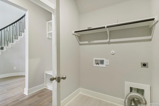 clothes washing area with hookup for a gas dryer, washer hookup, hookup for an electric dryer, and light wood-type flooring