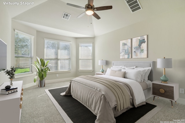 bedroom featuring ceiling fan, multiple windows, lofted ceiling, and light carpet