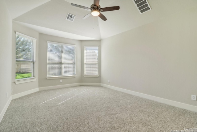 spare room with ceiling fan, lofted ceiling, plenty of natural light, and carpet flooring