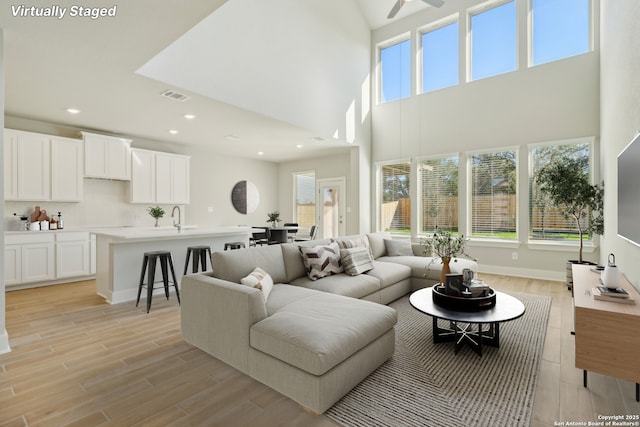 living room with sink and light hardwood / wood-style flooring