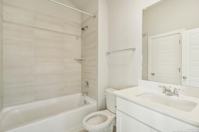 full bathroom featuring tiled shower / bath, vanity, and toilet