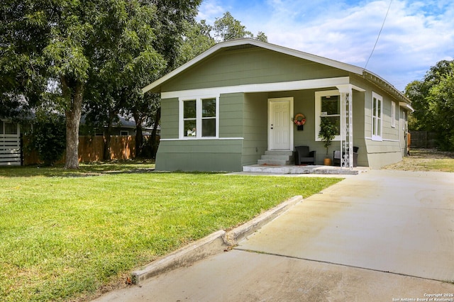 bungalow-style house featuring a front lawn