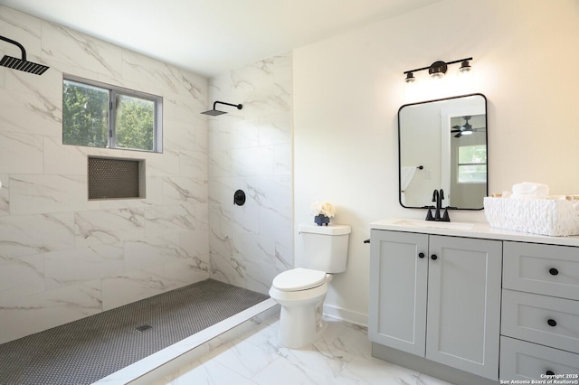 bathroom with vanity, toilet, and a tile shower