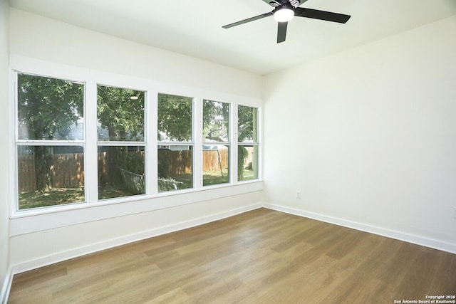 unfurnished room with wood-type flooring and ceiling fan