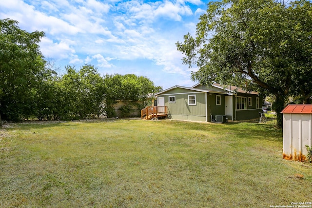 view of yard with a wooden deck and central AC unit