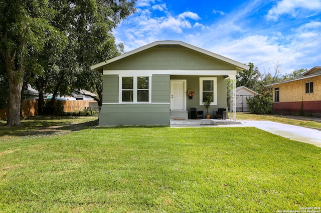 bungalow-style home with a front yard