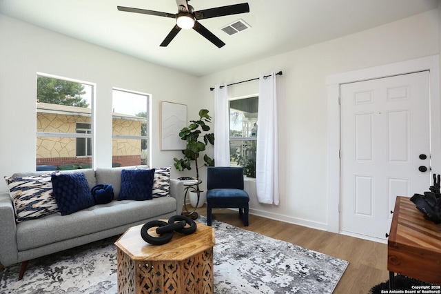 living room with hardwood / wood-style flooring and ceiling fan