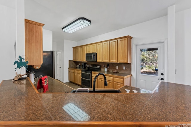 kitchen featuring range with two ovens, tasteful backsplash, stainless steel fridge, and kitchen peninsula