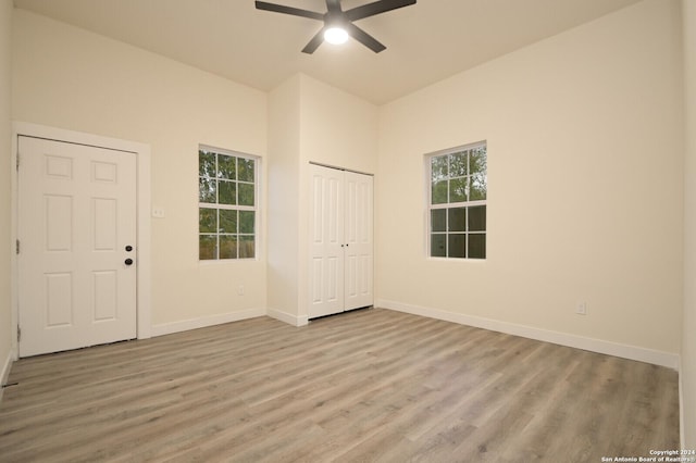 spare room with a wealth of natural light, light hardwood / wood-style flooring, and ceiling fan