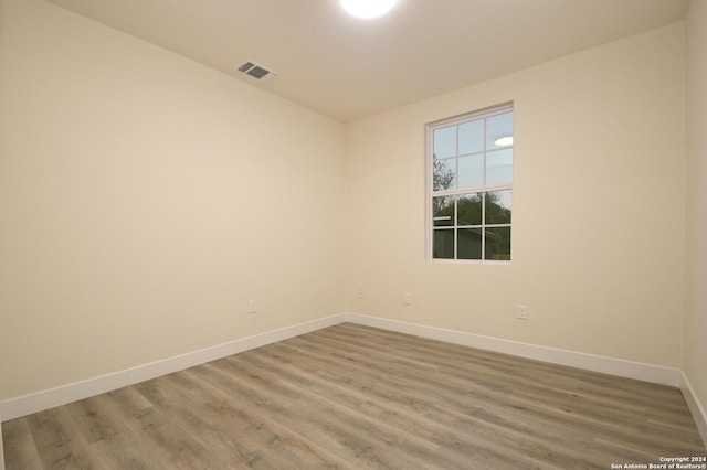 empty room with hardwood / wood-style flooring