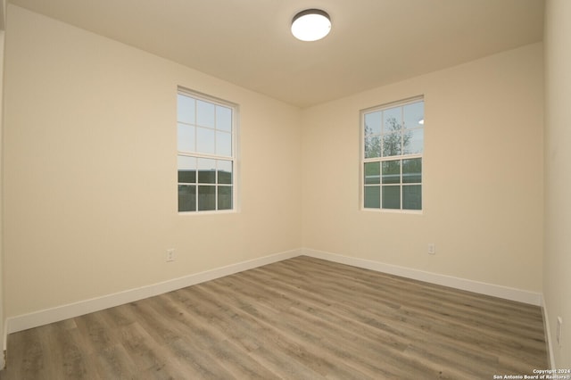 unfurnished room with hardwood / wood-style flooring