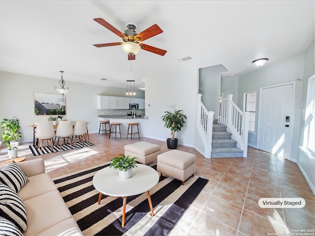 tiled living room featuring ceiling fan