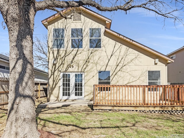 back of house with a wooden deck and french doors