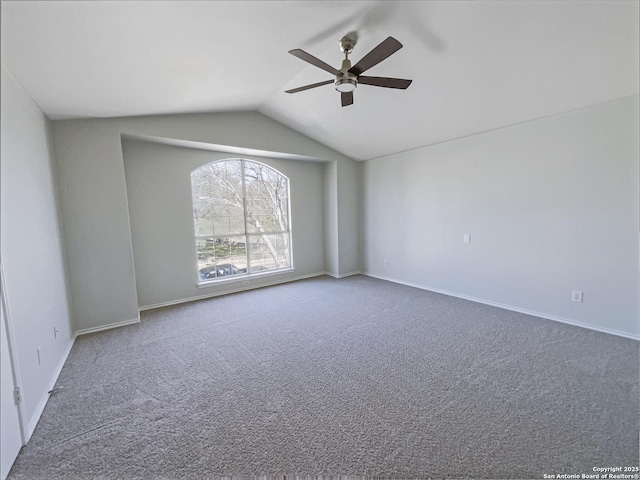 carpeted empty room with ceiling fan and vaulted ceiling