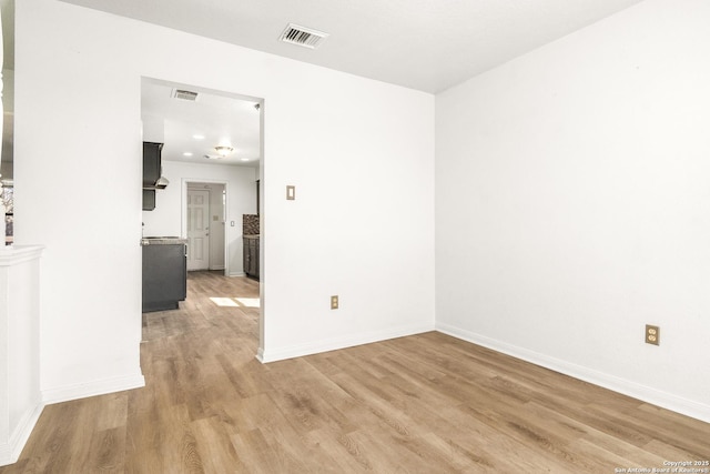 spare room featuring light hardwood / wood-style floors