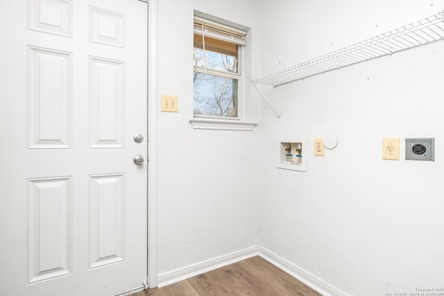 washroom with hardwood / wood-style flooring, gas dryer hookup, washer hookup, and hookup for an electric dryer