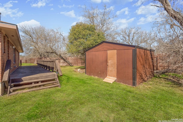 view of yard with a storage unit and a deck