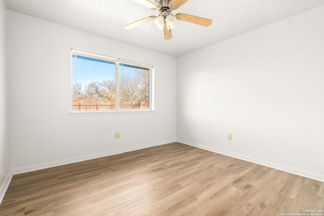 unfurnished room with ceiling fan and light wood-type flooring