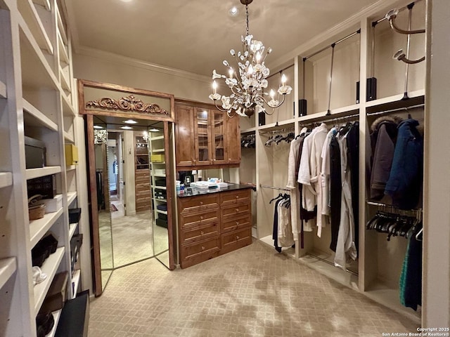 spacious closet featuring a chandelier