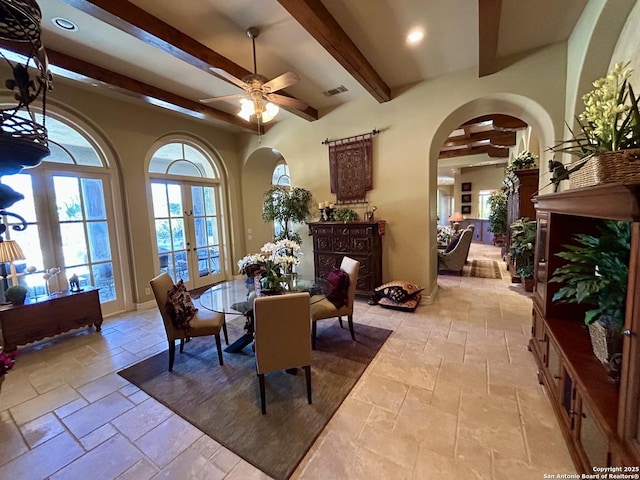 dining room featuring beamed ceiling, ceiling fan, and french doors