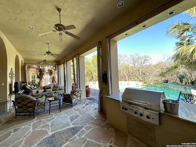 view of patio featuring an outdoor kitchen, area for grilling, an outdoor hangout area, and ceiling fan