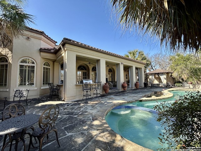 view of pool featuring a patio area and a bar