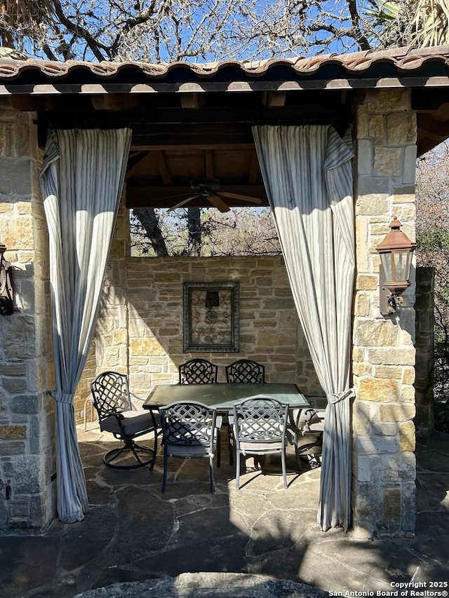 view of patio / terrace featuring ceiling fan