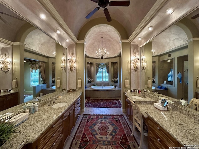 bathroom with vaulted ceiling, a tub, vanity, and crown molding